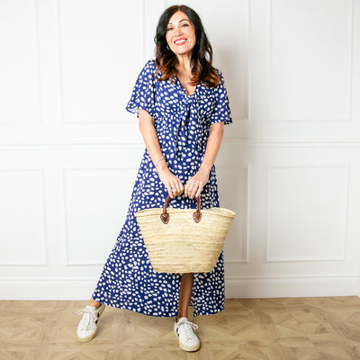 The Tie Front Picnic Dress in navy blue with a v neckline and a tie bow detail across the front